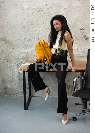 A Chic Outfit Featuring a Bright Yellow Backpack Paired with Stylish and Trendy Footwear 125180354