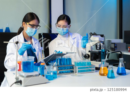 Glass vial, pipette and scientist in laboratory for medical study, research or experiment. Test tube, dropper and professional person with chemical liquid for pharmaceutical innovation. Glass vial, pipette and scientist in laboratory for medical study, research or experiment. Test tube, dropper and professional person with chemical liquid for pharmaceutical innovation. 125180994