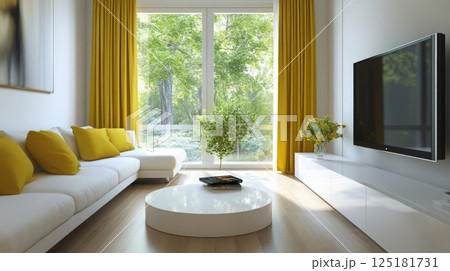 A modern living room features white walls, a white sectional sofa, yellow curtains by a large window overlooking a green forest, a white coffee table with books, and a mounted TV. 125181731