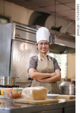 Portrait young teen girl cook student. Cooking class. Culinary classroom. Happy young woman students for cooking in cooking school. 125182665