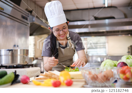 Focused chef preparing clean food ingredients from organic farm produce in a professional kitchen. Focused chef preparing clean food ingredients from organic farm produce in a professional kitchen. 125182746