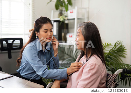 Healthcare and Compassionate Care. A nurse conducting a medical checkup for an elderly patient in a friendly atmosphere. Healthcare and Compassionate Care. A nurse conducting a medical checkup for an elderly patient in a friendly atmosphere. 125183018