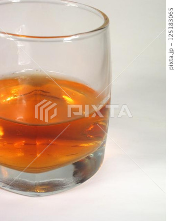 Glass of whiskey on white background Glass of whiskey on white background 125183065