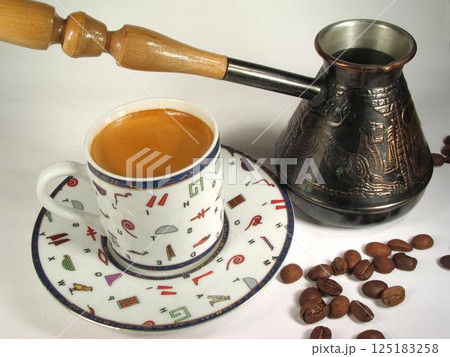 A cup of coffee on a table close view background A cup of coffee on a table close view background 125183258