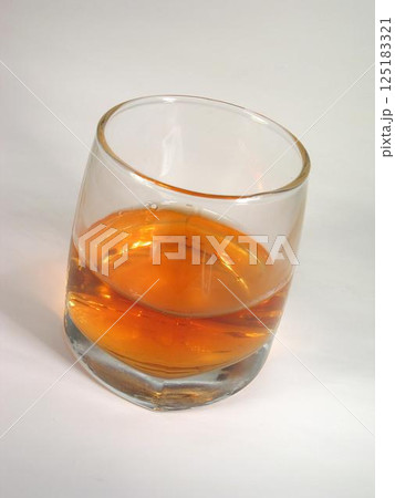 Glass of whiskey on white background 125183321