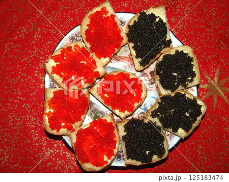 Red and black caviar over red background 125183474