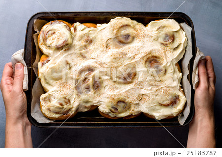 Homemade cinnabons with cinnamon and cream cheese. Homemade cinnabons with cinnamon and cream cheese. 125183787