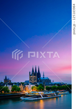 Great St. Martin Church And Dom In Cologne At Evening With Reflection In River Rhine, Germany. Cologne. Great St. Martin Church And Dom In Cologne At Evening With Reflection In River Rhine. Sunset 125183964
