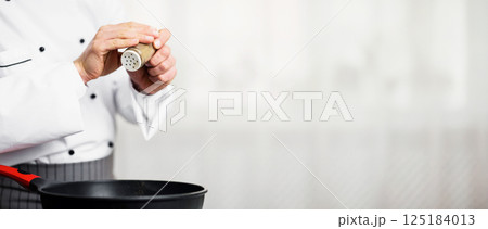 Unrecognizable Chef Adding Pepper Seasoning Disn In Frying Pan Cooking In Kitchen Indoor. Cropped, Empty Space, Selective Focus Unrecognizable Chef Adding Pepper Seasoning Disn In Frying Pan Cooking In Kitchen Indoor. Cropped, Empty Space, Selective Focus 125184013