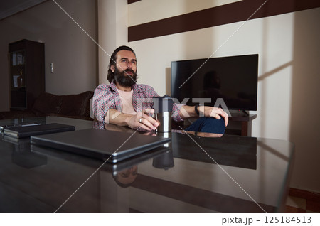 Young Professional Relaxing at Home Office With Work Materials 125184513