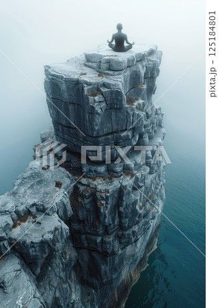 Meditation on the edge. Photo of a meditating human on the edge of a high cliff. Balancing on the edge, the meditator embraces the beauty of the unknown. Meditation on the edge. Photo of a meditating human on the edge of a high cliff. Balancing on the edge, the meditator embraces the beauty of the unknown. 125184801