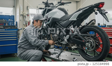バイクのメンテナンスをするアジア人整備士 バイクのメンテナンスをするアジア人整備士 125184998