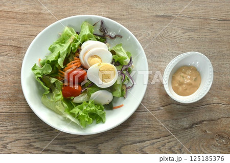 boiled egg with vegetable thousand island salad on plate dressing cream sauce boiled egg with vegetable thousand island salad on plate dressing cream sauce 125185376