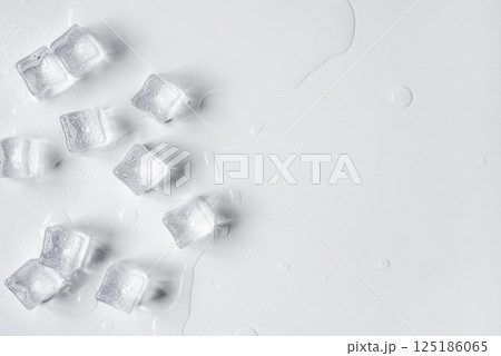 Melting ice cubes in a splash of water on a white background 125186065