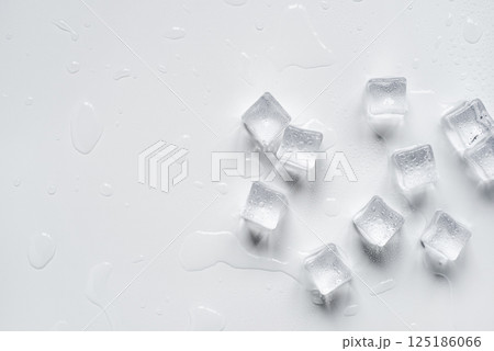 Melting ice cubes in a splash of water on a white background Melting ice cubes in a splash of water on a white background 125186066