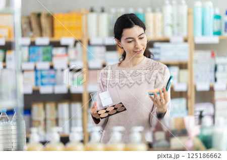 Woman choosing cosmetics at the pharmacy Woman choosing cosmetics at the pharmacy 125186662