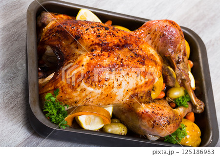 Turkey baked with vegetables and apples Turkey baked with vegetables and apples 125186983