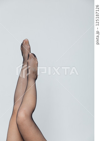 Long Female Legs In Black Stockings Tights On White Background 125187126