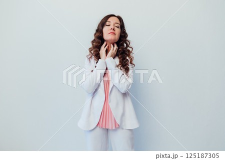 woman hugging herself on white office background 125187305