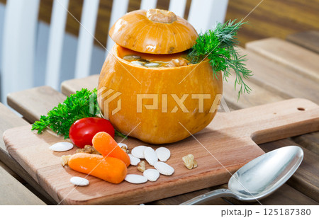 Recipe of squash soup in baked pumpkin 125187380