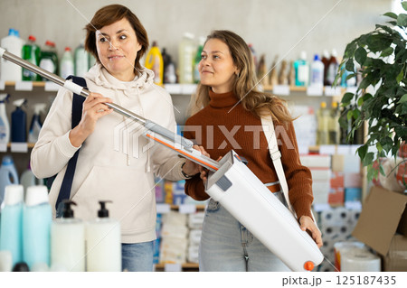 Two women choosing mop in department store 125187435