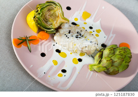 Deliciously fillet of fried horse-mackerel with sauce and artichokes 125187830