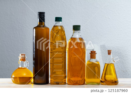 Assortment of olive oil on wooden table Assortment of olive oil on wooden table 125187960