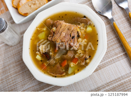 Mushroom nutritious soup with pork and other ingredients closeup Mushroom nutritious soup with pork and other ingredients closeup 125187994