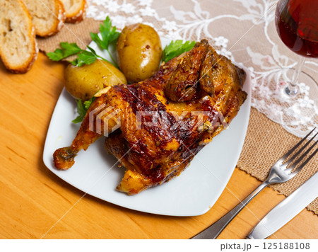Grilled chicken piece and potatoes served in a plate Grilled chicken piece and potatoes served in a plate 125188108