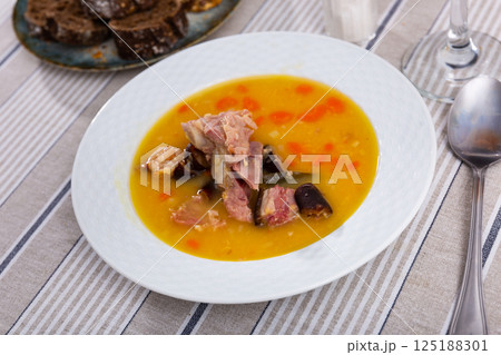 delicious pea soup with smoked meats 125188301