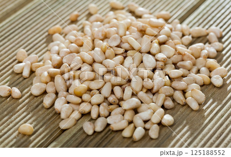 Picture of wooden desk with raw pine nut, nobody 125188552