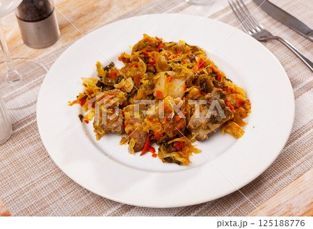 Plate of braised sauerkraut with fried pork meat Plate of braised sauerkraut with fried pork meat 125188776