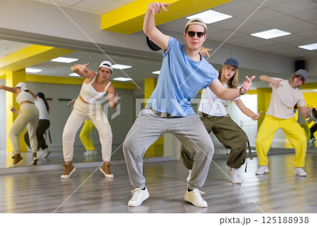 Teenage boy training breakdance Toprock moves in dance hall 125188938