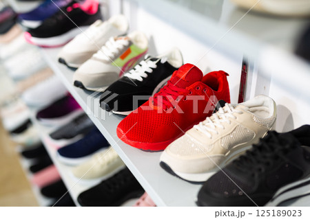 Rows of sportive footwear in shoeshop 125189023