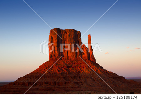 Monument Valley West Mitten at sunset sky 125189174
