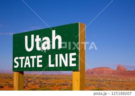 Road sign between Utah and Arizona State Line 125189207