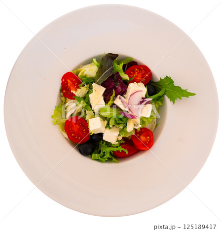 Plate of colorful salad of fresh greens, vegetables and cheese 125189417
