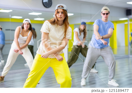 Teen girl in cap dances hip hop dances Teen girl in cap dances hip hop dances 125189477