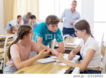 Fellow students having group work tasks during school Fellow students having group work tasks during school 125189481