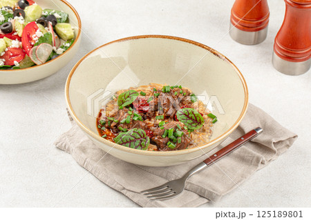 Portion of pasta orzo with meat and basil Portion of pasta orzo with meat and basil 125189801