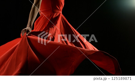 Closeup of Woman in red dress dancing with flying fabric, Fashion Model Girl Posing with waving cloth. Closeup of Woman in red dress dancing with flying fabric, Fashion Model Girl Posing with waving cloth. 125189871