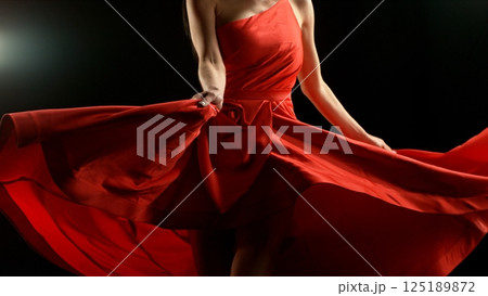 Closeup of Woman in red dress dancing with flying fabric, Fashion Model Girl Posing with waving cloth. Closeup of Woman in red dress dancing with flying fabric, Fashion Model Girl Posing with waving cloth. 125189872