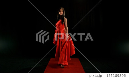 Woman in red dress dancing with flying fabric, Fashion Model Girl Posing with waving cloth Woman in red dress dancing with flying fabric, Fashion Model Girl Posing with waving cloth 125189896