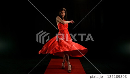 Woman in red dress dancing with flying fabric, Fashion Model Girl Posing with waving cloth Woman in red dress dancing with flying fabric, Fashion Model Girl Posing with waving cloth 125189898