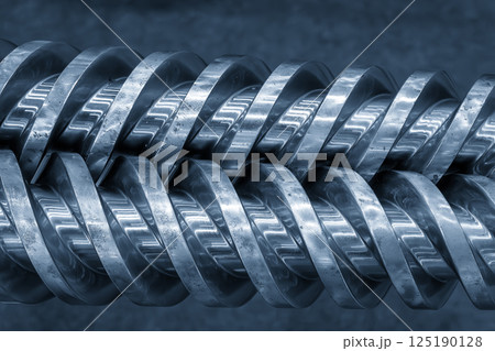 Close up scene body of the barrel screw of injection machine spare parts in the light blue scene. 125190128