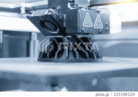 Close up scene the additive manufacturing by 3D printer machine in the light blue scene. 125190129