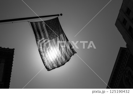 US american symbol flag over Black and white city 125190432