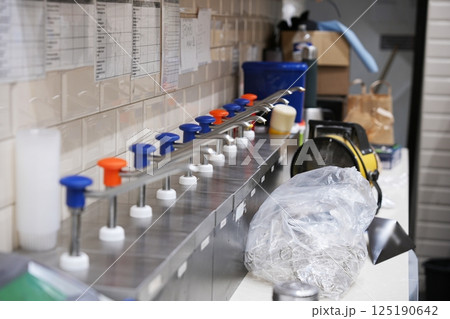 Condiment Dispenser Station in Belgian Fry Shop Kitchen Condiment Dispenser Station in Belgian Fry Shop Kitchen 125190642