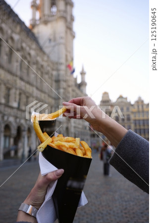 Eating Belgian Fries with Sauce in Grand Place, Brussels Eating Belgian Fries with Sauce in Grand Place, Brussels 125190645