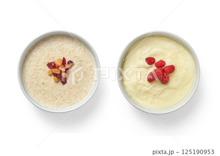 Two portions of oatmeal porridge for breakfast isolated on white background 125190953